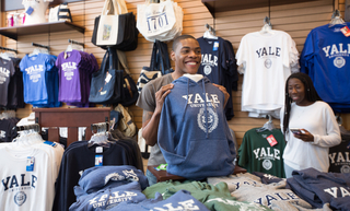 Person shopping and holding up a tshirt